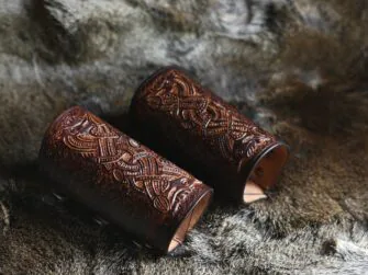 Long dark brown leather wrist cuffs on the hairy hide.