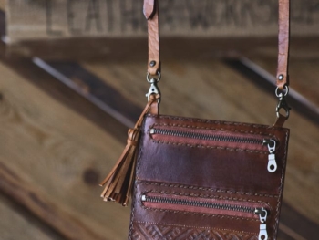 Leather neck wallet with carved folk pattern