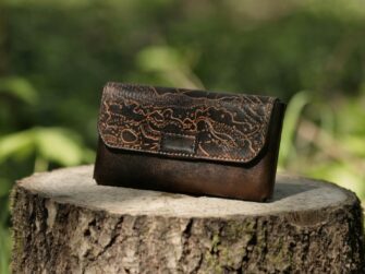 Leather belt bag with magnet lock, decorated by hand carved orienteering map