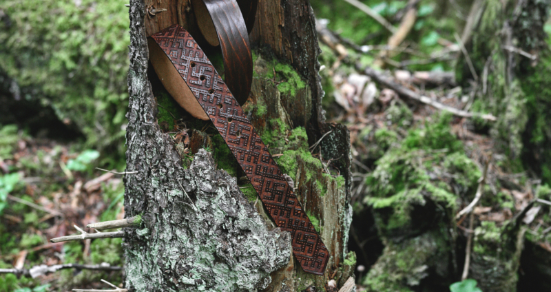 Dark brown leather belt with svastika carvings