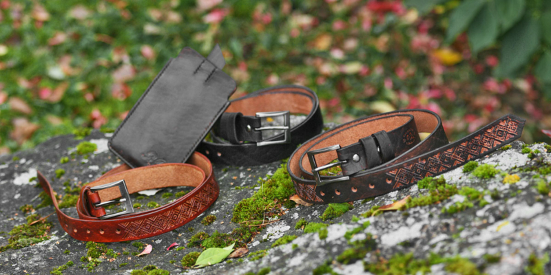 Set of carved leather belts and a phone sleeve