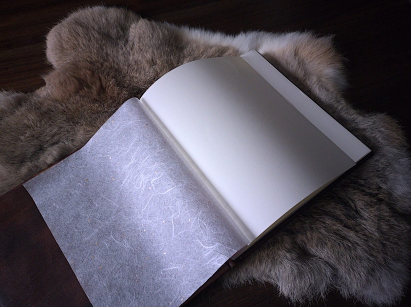 Book is placed onto furry rabbit skin. Photo presents the end papers.