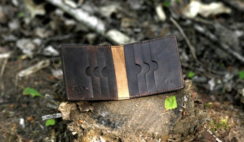 Dark brown carved leather card case with eight pockets.