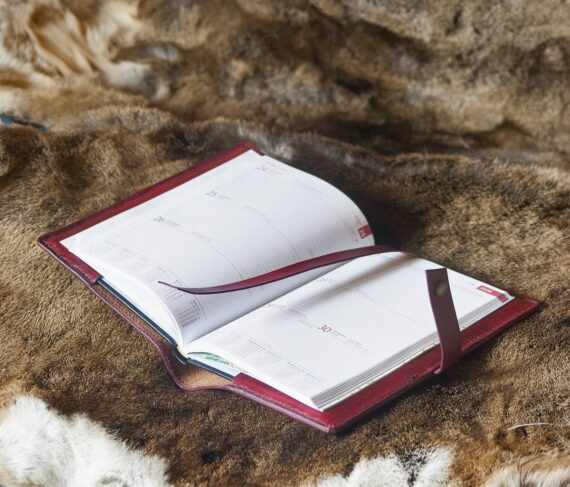 Red leather notebook covers with hand carved floral pattern, inside