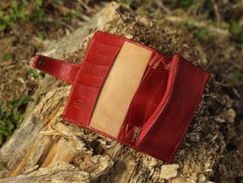 Large red leather wallet for women with hand carved swallows and feather image.