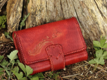 Large red leather wallet for women with hand carved swallows and feather image.