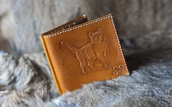 Yellow leather wallet with a cat