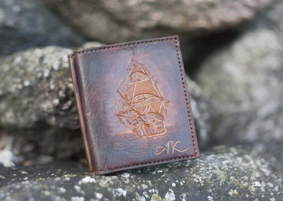 Dark brown leather wallet with a sailing ship image