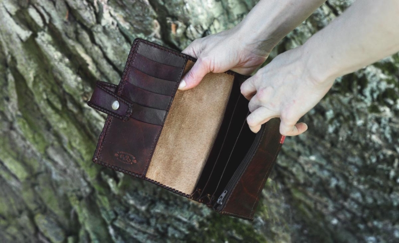 Large leather womens wallet with laced edges and hand carved pattern, inside.